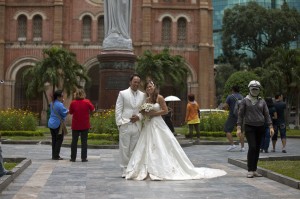 A common site in HCMC, wedding photography with the architecture of the Duc Ba Cathedral in the background.